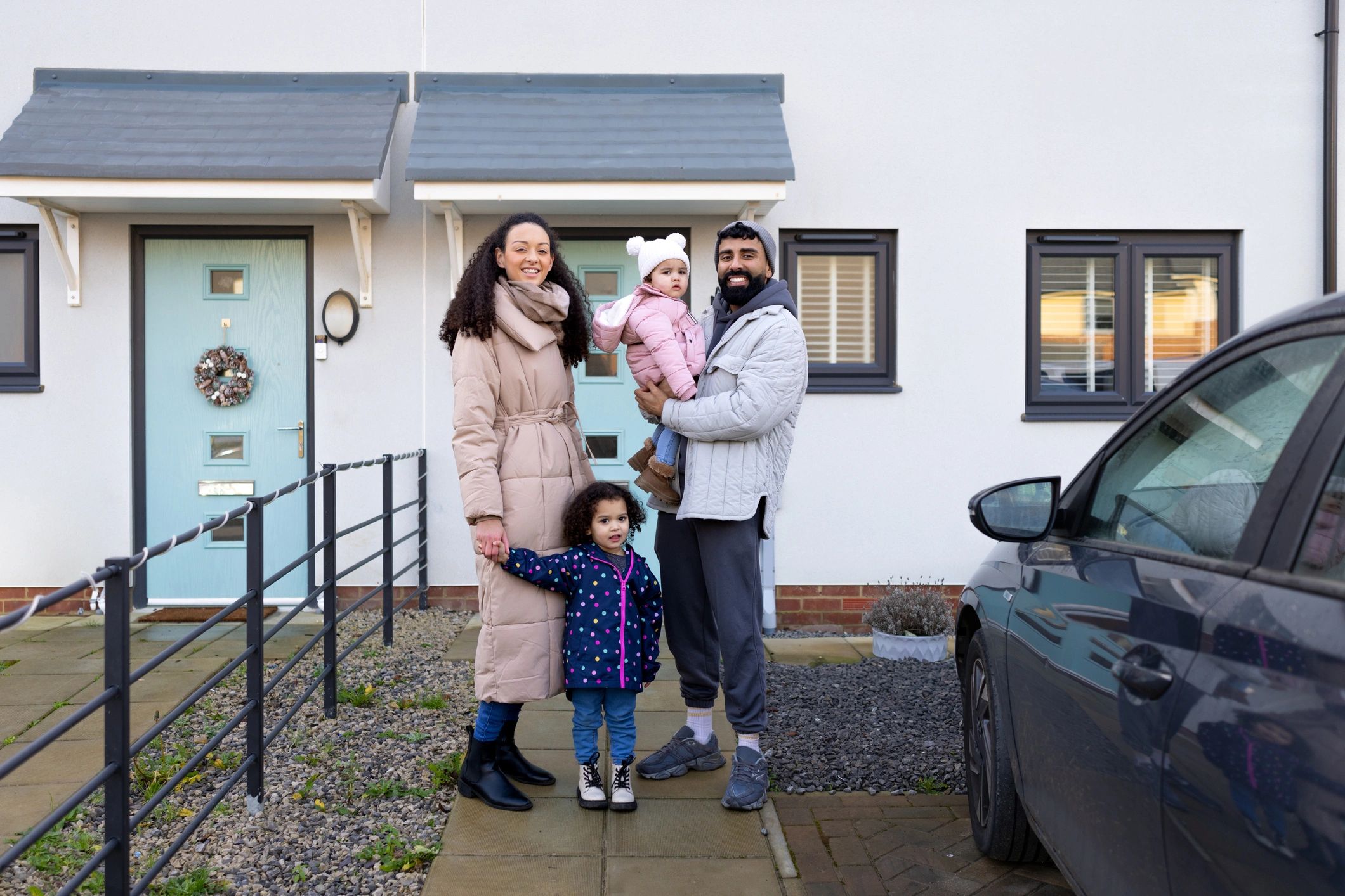 Happy homeowners outside their home
